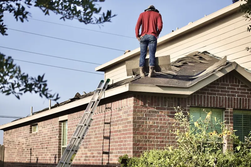 Professional roofer working on a residential roof in Central Park
